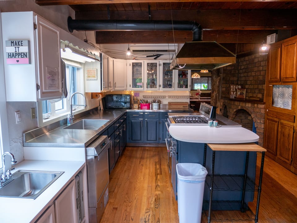 Main Kitchen: Double oven, 2 fridges, freezer, 2 sinks, microwave, cookware