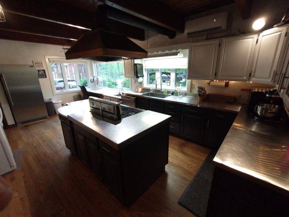 Main Kitchen: Double oven, 2 fridges, freezer, 2 sinks, microwave, cookware