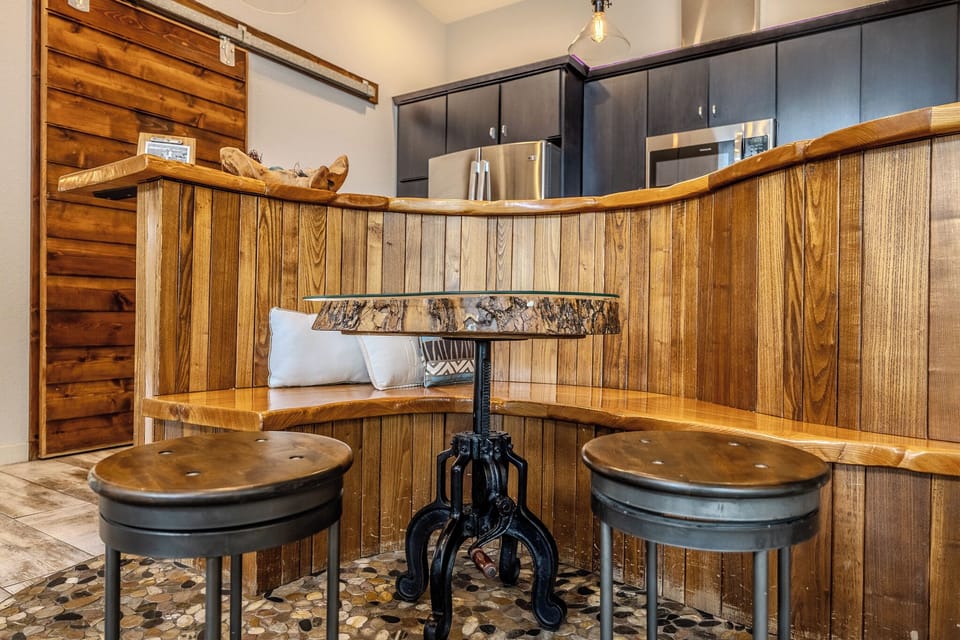 Cozy nook with rustic wood and stylish seating, perfect for a relaxing stay.