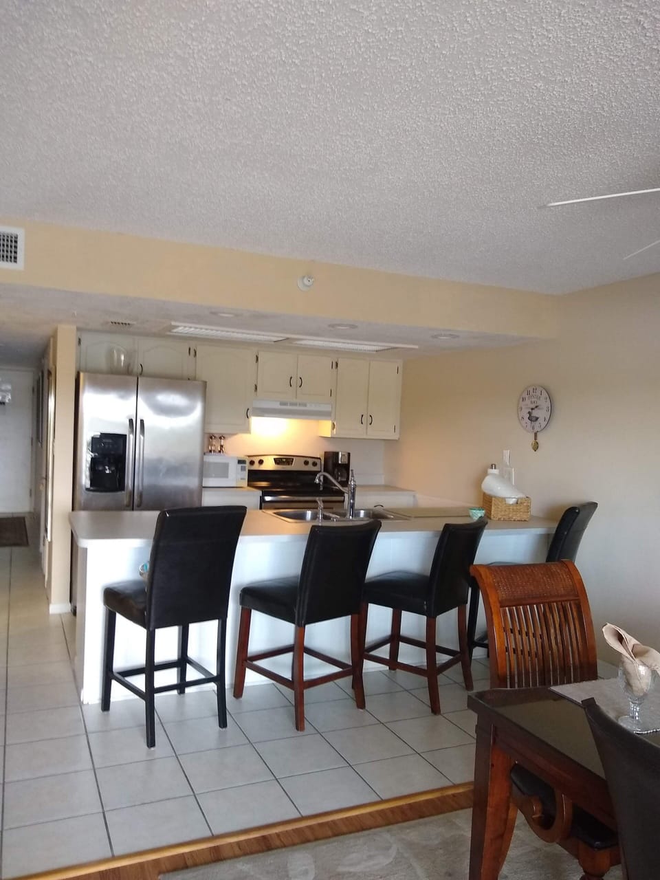 Kitchen bar with 4 stools and laughter.