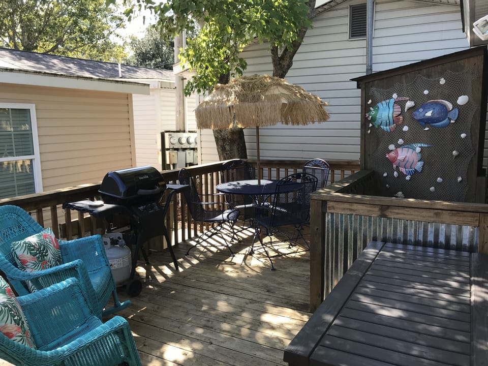 Outdoor shady porch with gas grill 