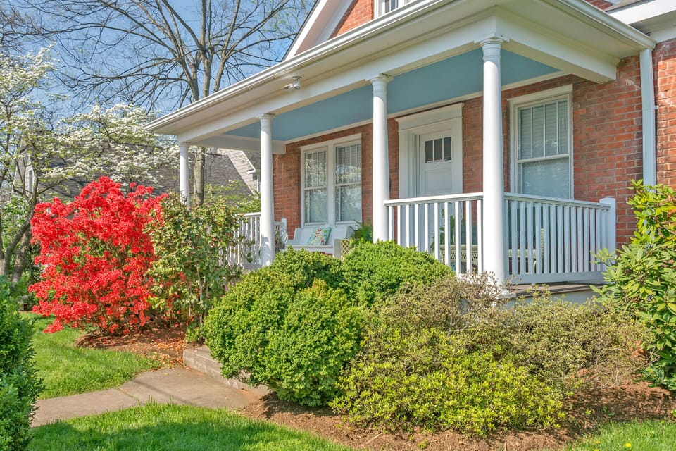 Welcoming front porch with beautiful native landscaping