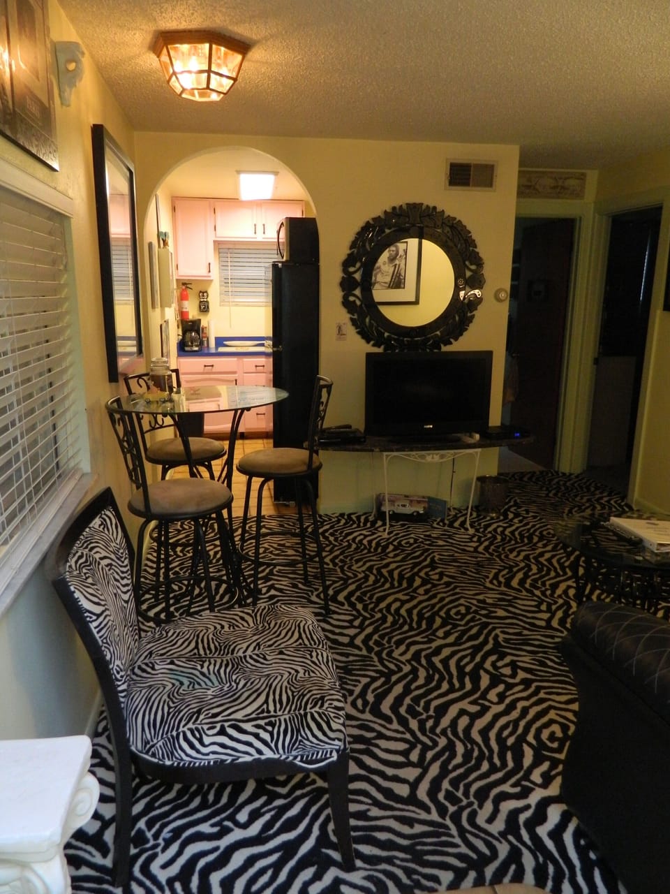 Living room with zebra carpet and chair and pub table