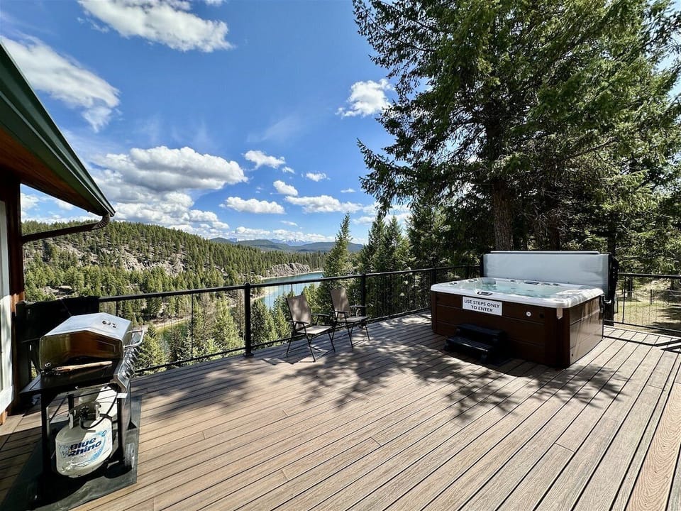 Large deck with hot tub and propane grill. The view from the deck overlooks Bootjack Lake and promises to share breathtaking scenery.