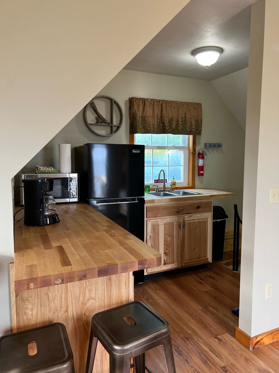 Kitchenette with refrigerator, microwave, sink, toaster, coffee pot, Keurig 
