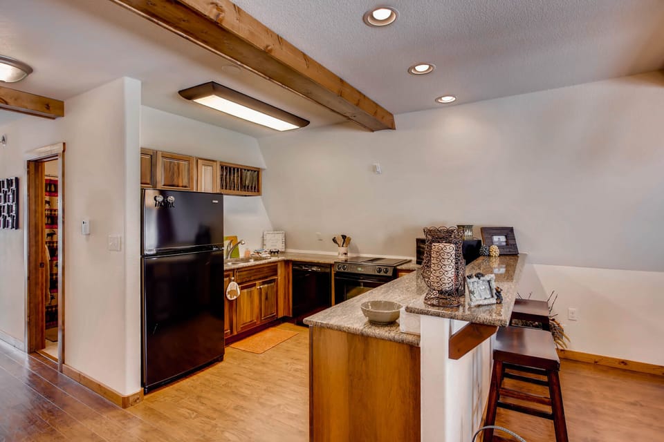 The spacious kitchen is open with modern stainless appliances and gorgeous granite counter tops.