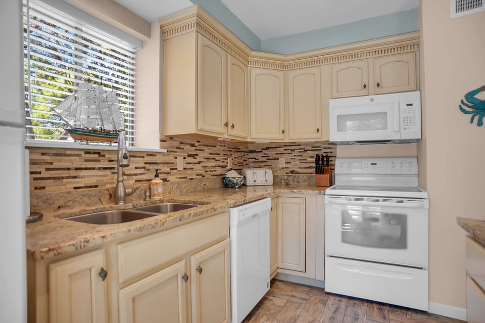 Kitchen is well-equipped for preparing meals for a family