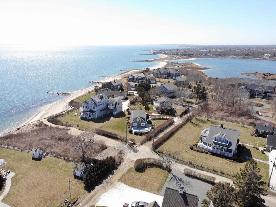 cape house in center overlooking private lot.