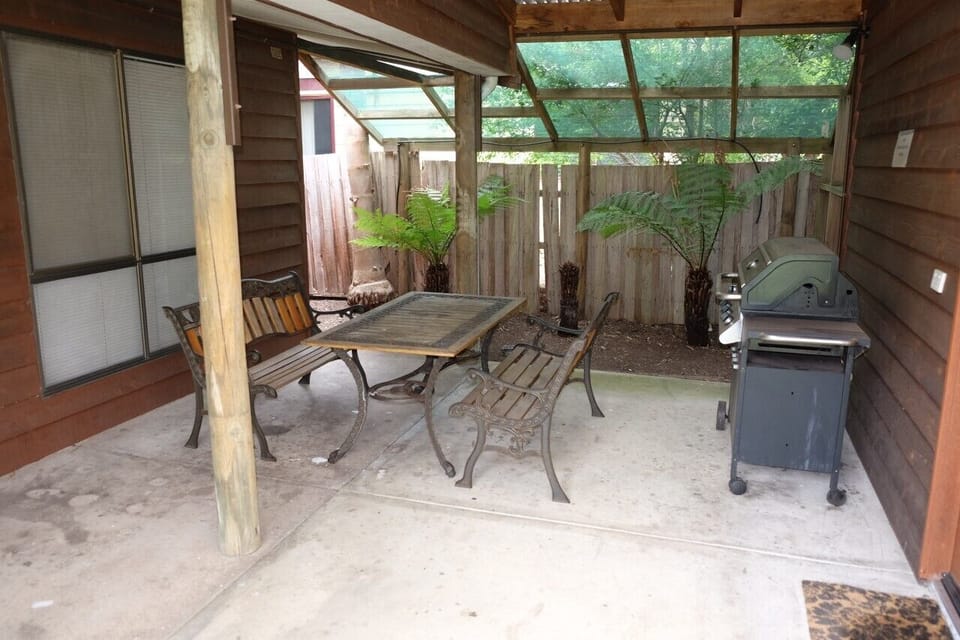 Covered outdoor dining area with BBQ