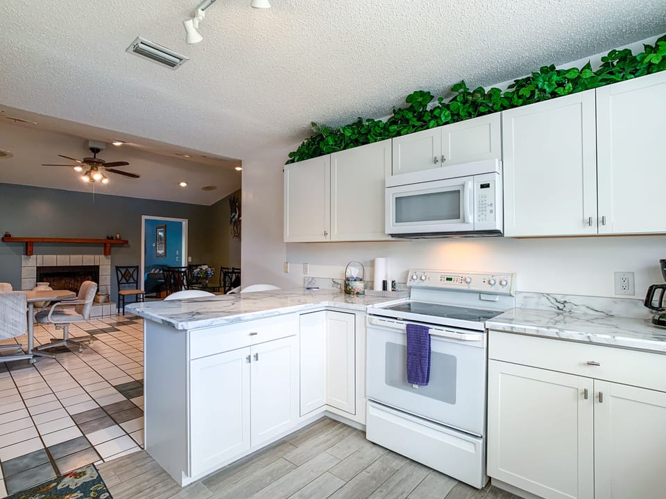 Oven, stove, microwave, coffee pot open to dining room for easy conversation.