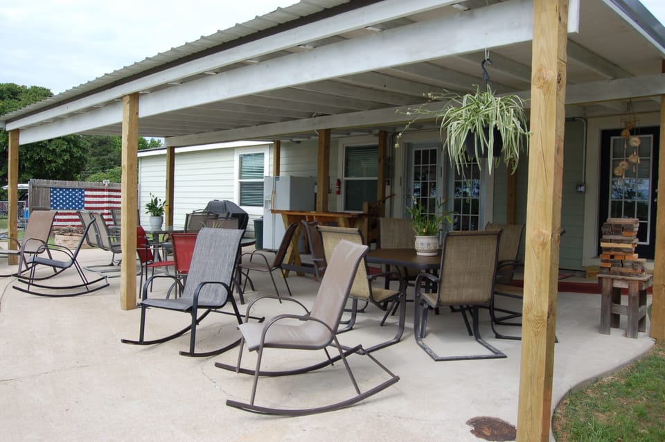 Back patio (plenty of seating, tables, fridge/freezer combo, grill, & fire pit)