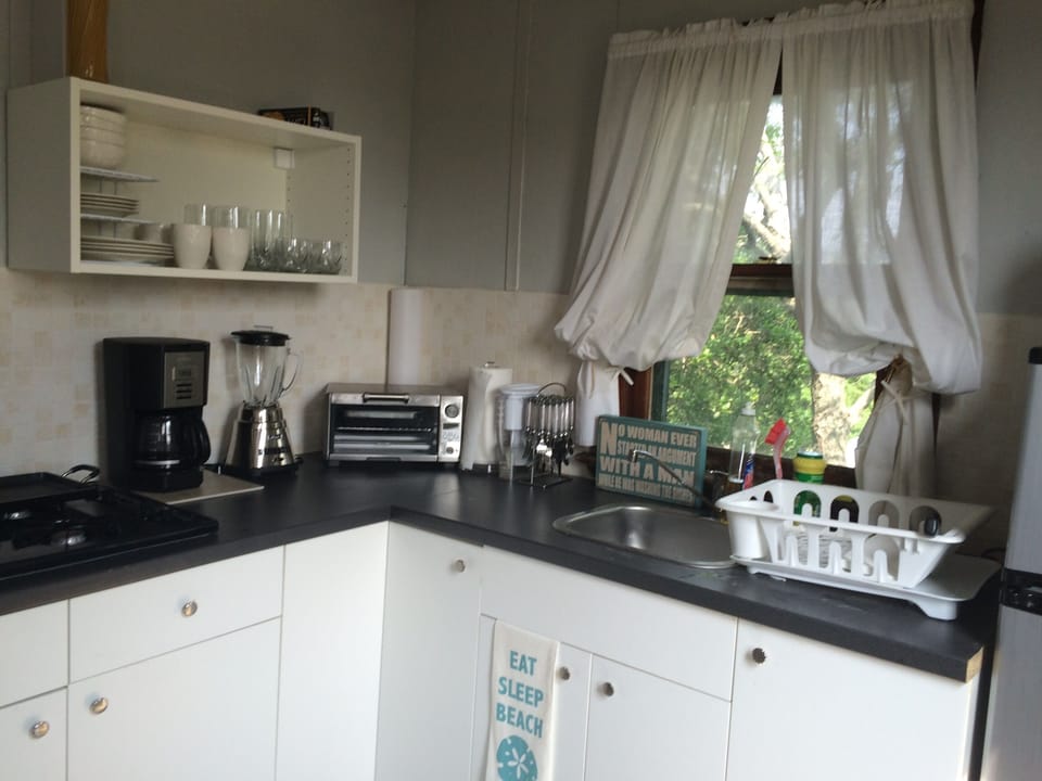 Efficient kitchen.
rangetop, coffeemaker,  toaster oven,  fridge and microwave.