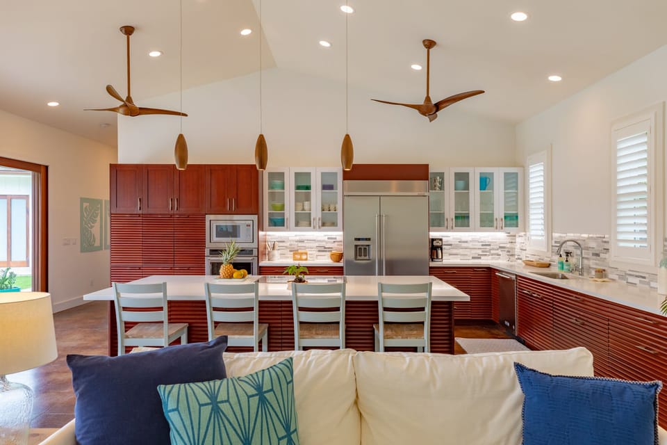 Casual bar seating invites conversation while meals are prepared, making the kitchen the social hub of the home.