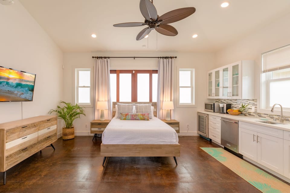 Another view of the studio suite, showing spacious layout and direct access to outdoor living areas.