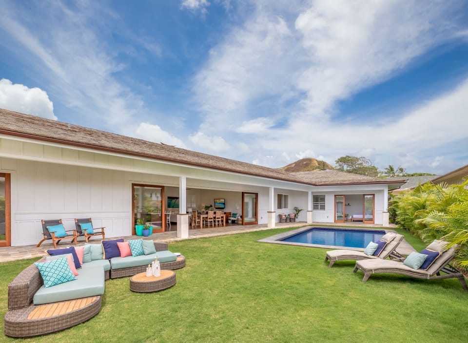 Comfortable outdoor seating around the pool creates the perfect spot for afternoon lounging or evening cocktails.