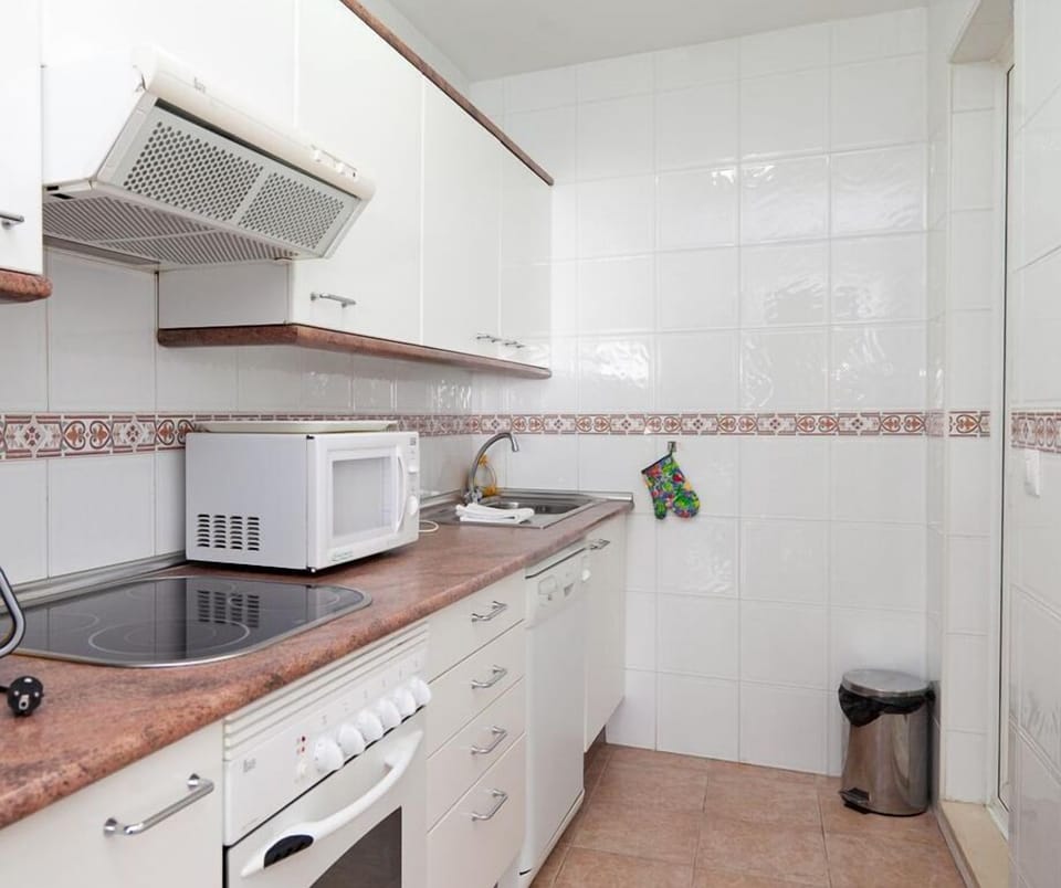 Kitchen in this apartment is fully fitted with all the appliances