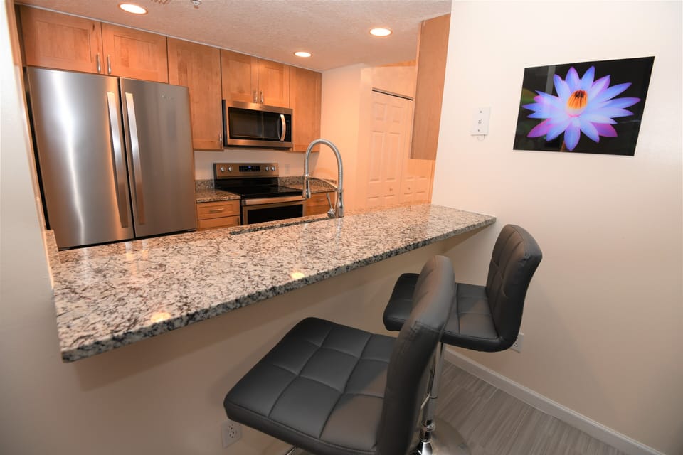 New stainless steel appliances, with maple cabinets and granite counter tops. 