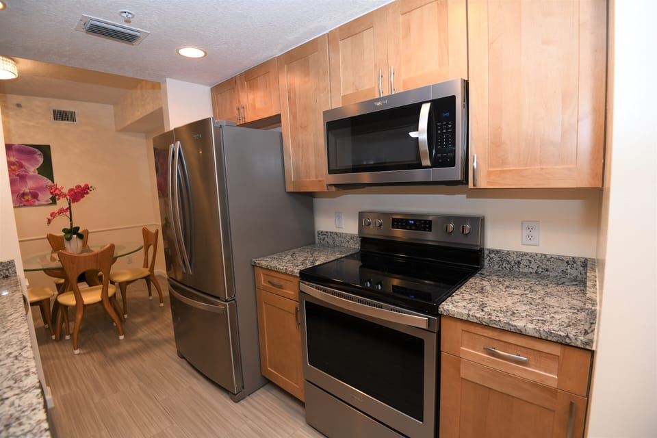 New stainless steel appliances, with maple cabinets and granite counter tops. 