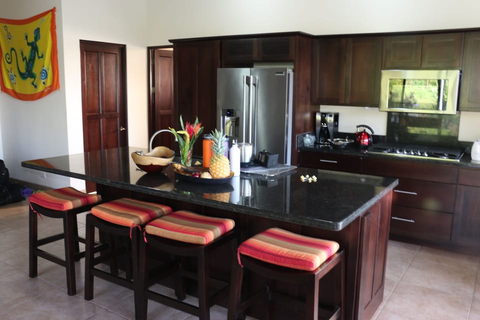 Kitchen with sit up Island granite counter. Modern appliances.