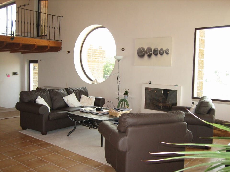 Enjoy the coolness of the sitting room with views over the village.