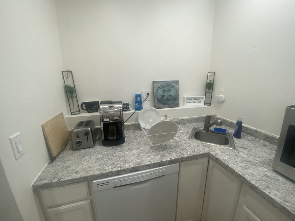 Kitchenette with shelves and dishwasher 