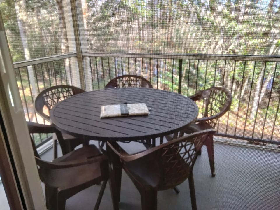enclosed patio overlooking conservation with table and chairs 
