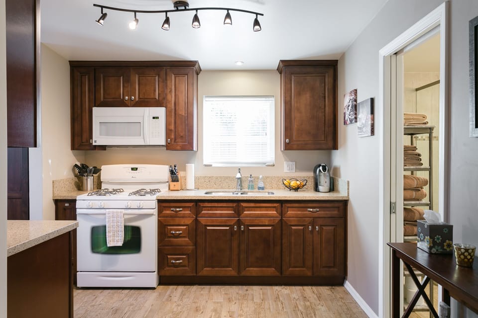 Beautiful kitchen with lots of light & fully stocked cabinets w/ all you'll need