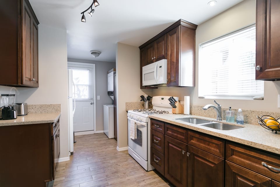 The washer, dryer, fridge, and small pantry are at the end.
