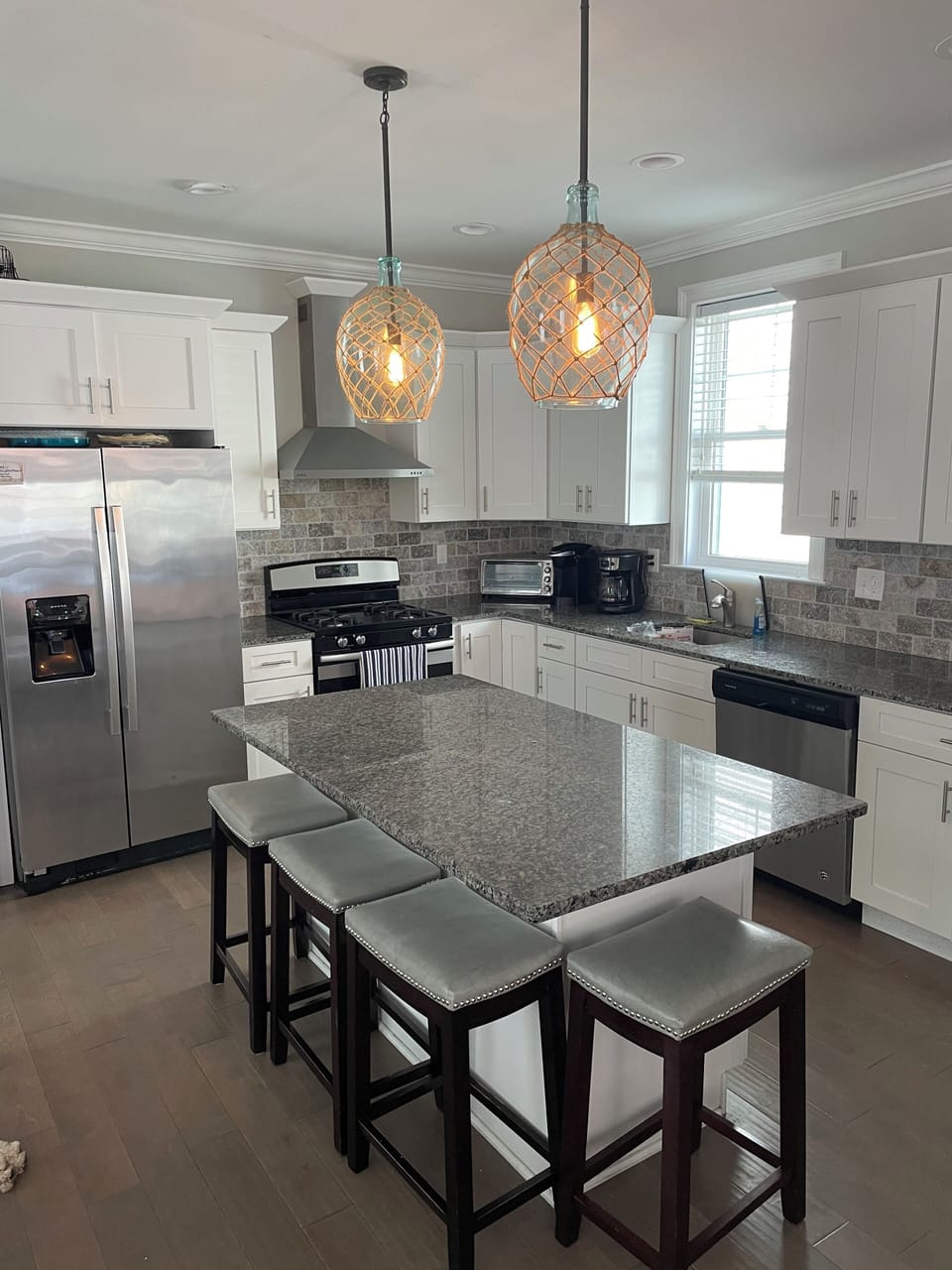 Kitchen has modern stainless steel appliances and an island.
