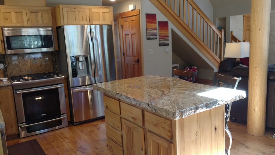 Modern kitchen with large pantry for storage.