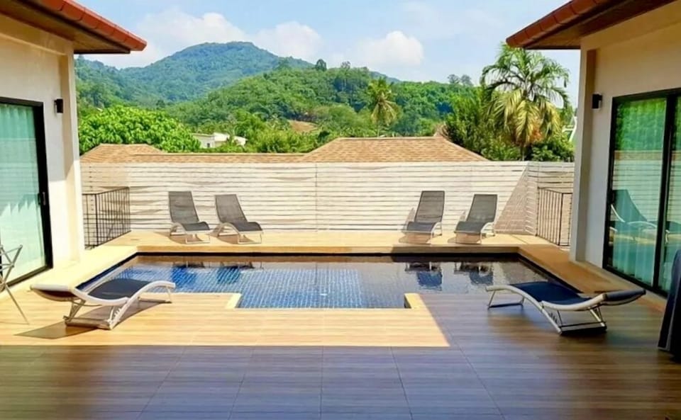 Tranquil private swimming pool with integral jacuzzi, adjacent to BBQ and soft seating area