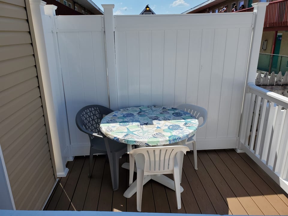 Deck in back yard with table great for morning coffee! 