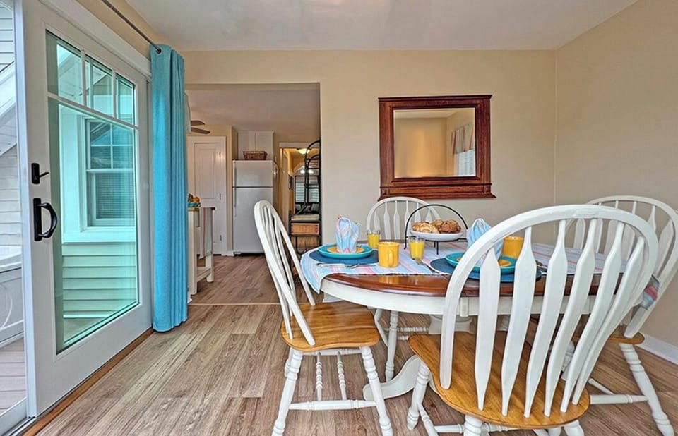 Dining room and view into kitchen at Blue Hydrangea Cottage in Belmar.
