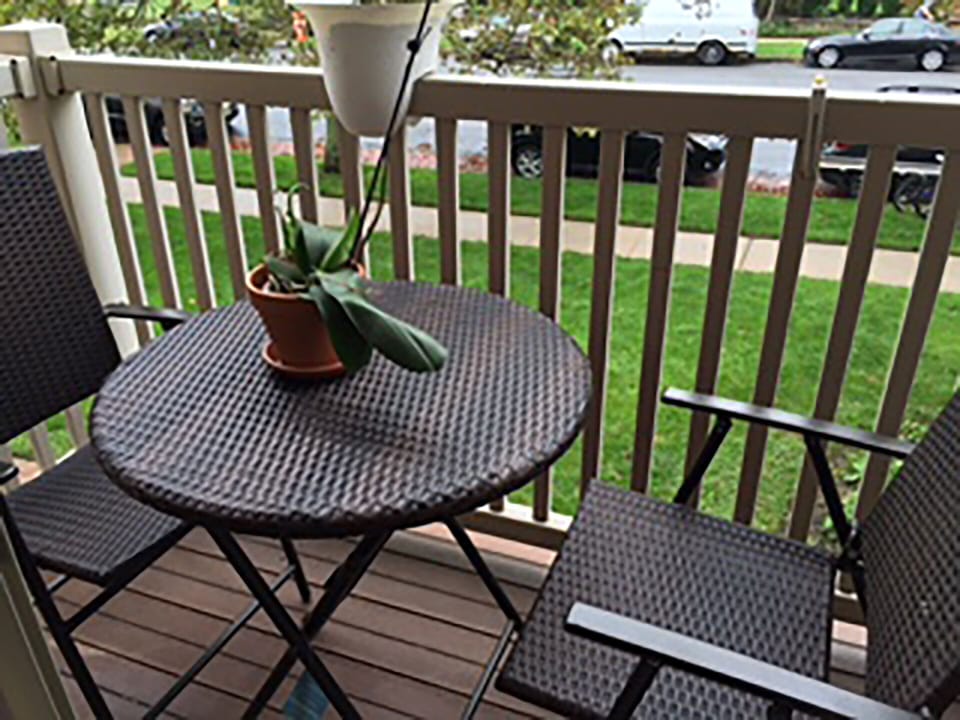 Balcony features a bistro table with matching chairs. Have a cup of coffee here!