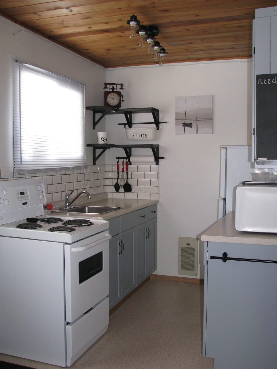 Kitchen has stove, fridge, microwave, small appliances, all dishes and cutlery