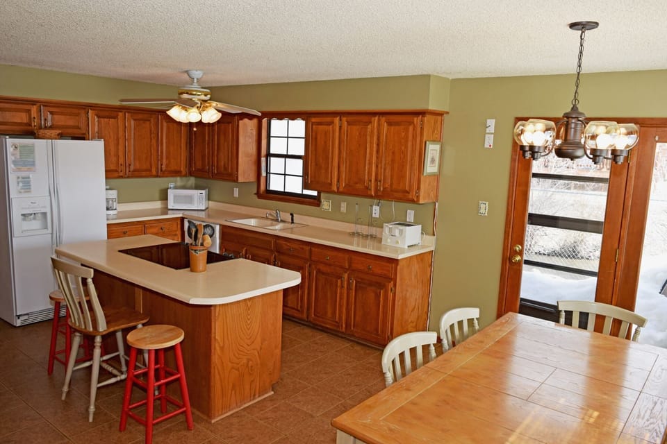 Your fully equipped kitchen opens to a bright dining area, where meals come together easily and linger over conversation.