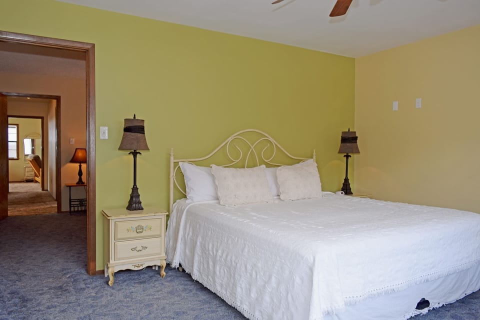 Sink into crisp white linens under the gentle glow of bedside lamps. Your spacious bedroom features a charming vintage-style bed and connects to the rest of your home.