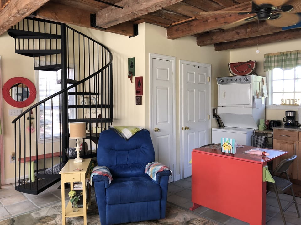 Spiral Staircase to Loft Bedroom Area storage room and Bath next to W/D