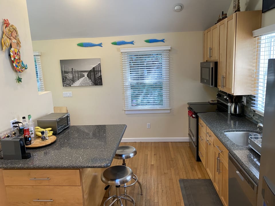 Another view of kitchen and island.
