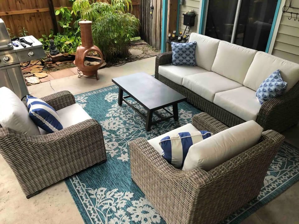 Back covered patio poolside with chiminea for cool nights . Jenn Aire gas grill 