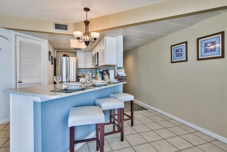 For casual dining, there are 3 bar stools at the quartz kitchen counter.