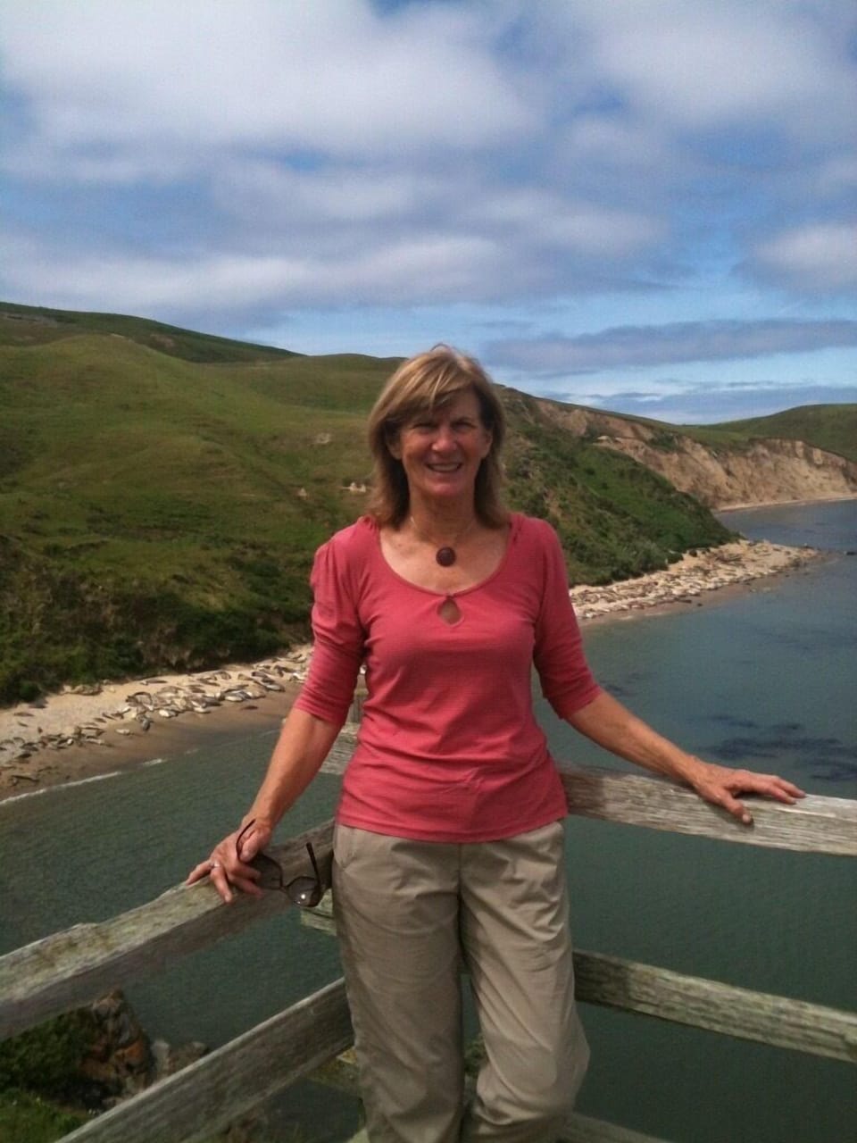 Carol at Point Reyes with elephant seals behind her (they look like logs)