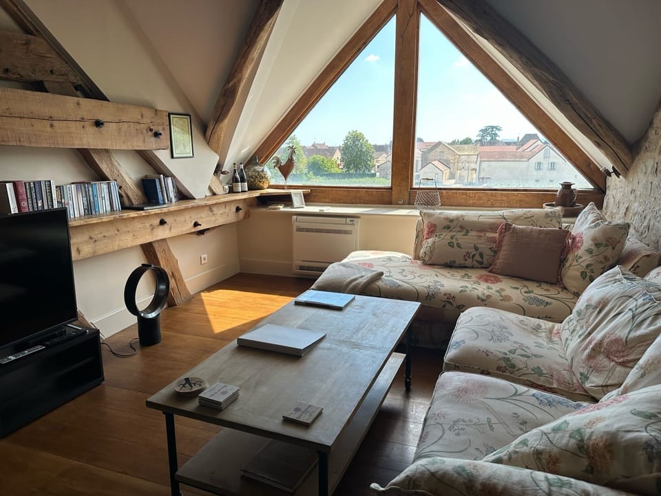 Living area (upstairs) with large window onto vines