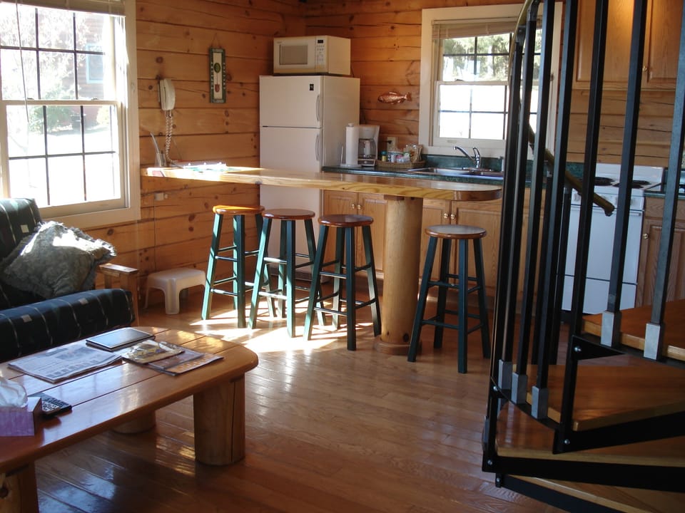 Kitchen and living space. Spiral staircase to the loft