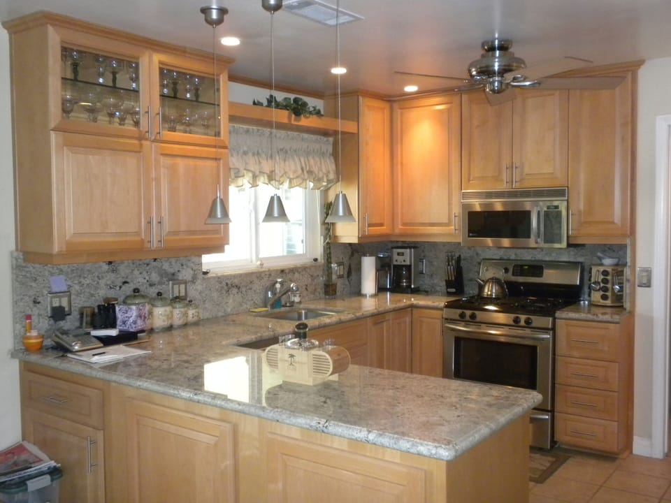 Updated kitchen is fully equipped with granite and stainless steel appliances.