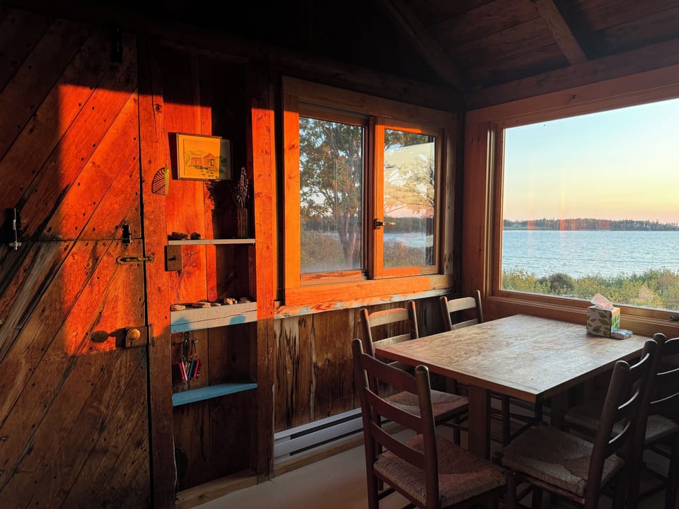 KITCHEN with table and split barn-door to side porch