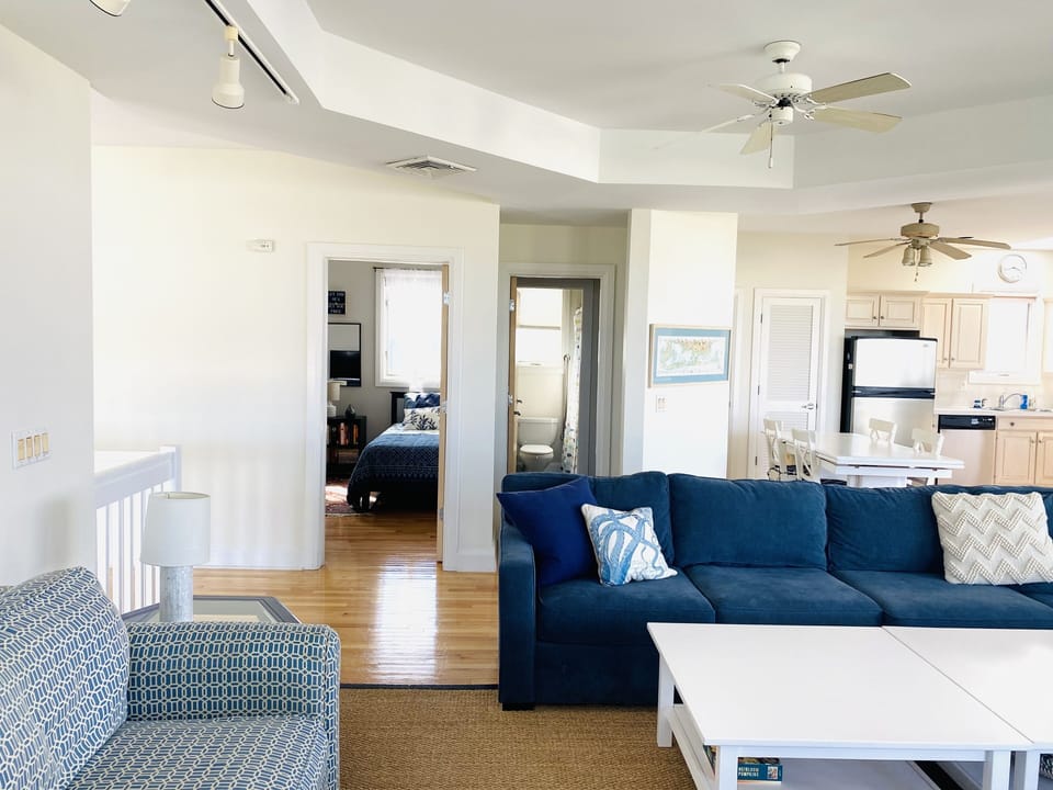 Bayside living room with bedroom and full bath in the background.