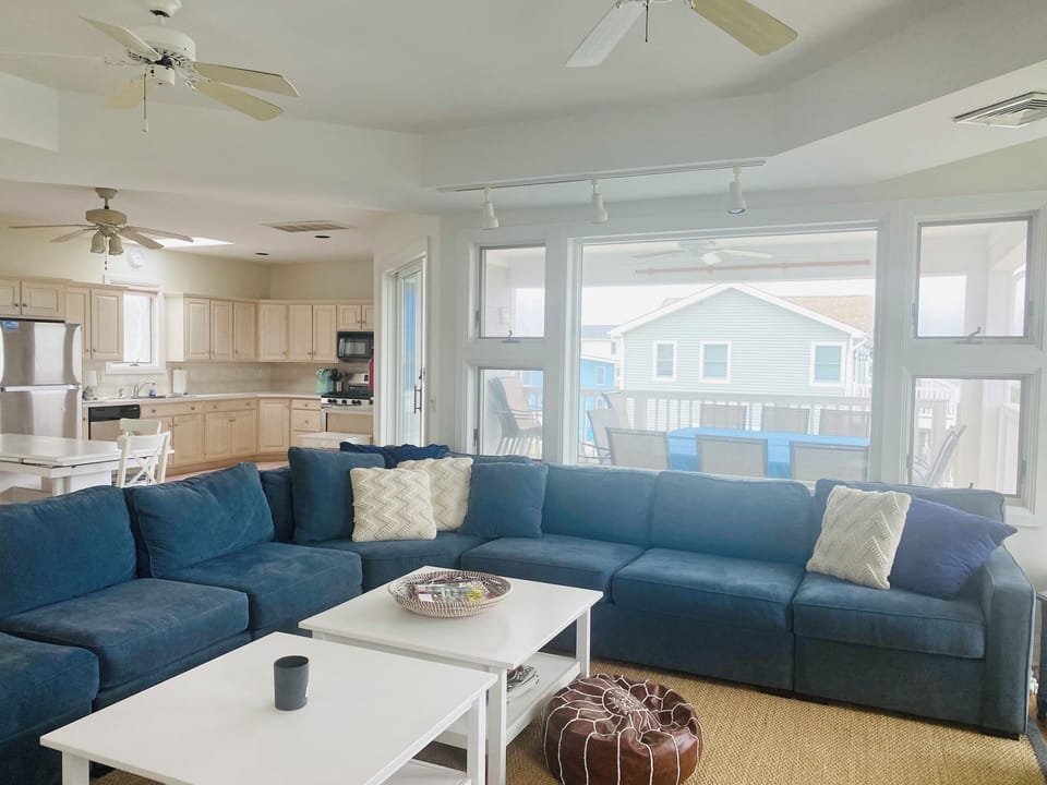 Full kitchen #1 & living room overlooks covered porch w/ water views of the bay.