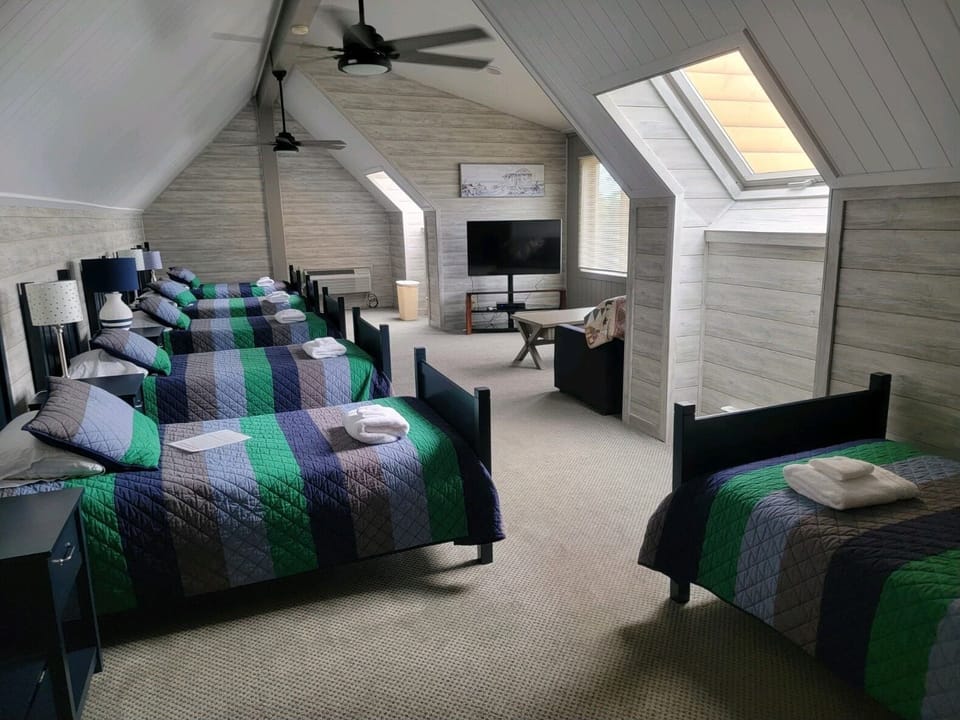 Newly remodel children's bedroom with 6 twin beds and 1 pull out sleeper sofa