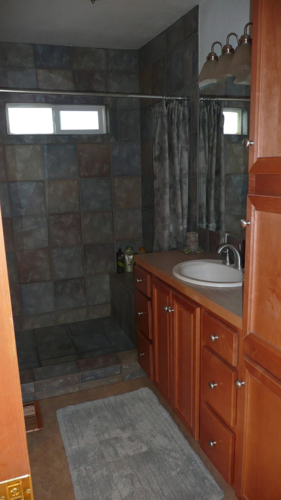 Main bathroom. Tiled shower with seating surface.
